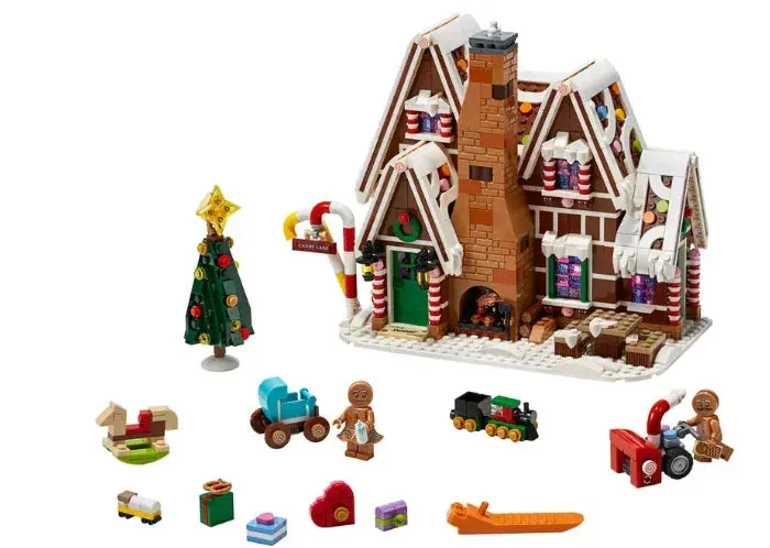 LEGO Winter Village Gingerbread House 10267 displayed in a UV-resistant acrylic case, surrounded by miniature snowmen and LED lights, creating a festive holiday scene.