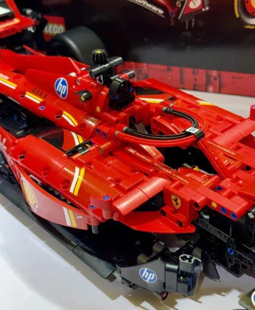 LEGO Ferrari F1 Racer 42207 on a rotating turntable, emphasizing its aerodynamic design and adjustable rear wing.