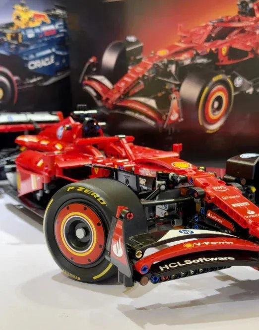 LEGO Ferrari F1 Racer displayed alongside a Ferrari team cap and racing gloves, creating a motorsport-themed setup.